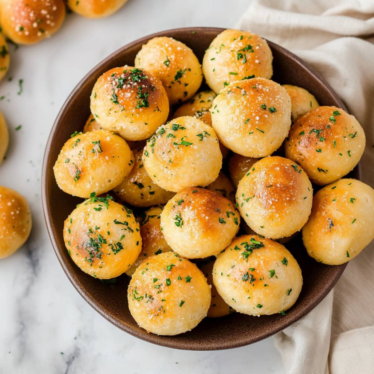 Garlic butter cheesy biscuits bombs in a bowl, top view