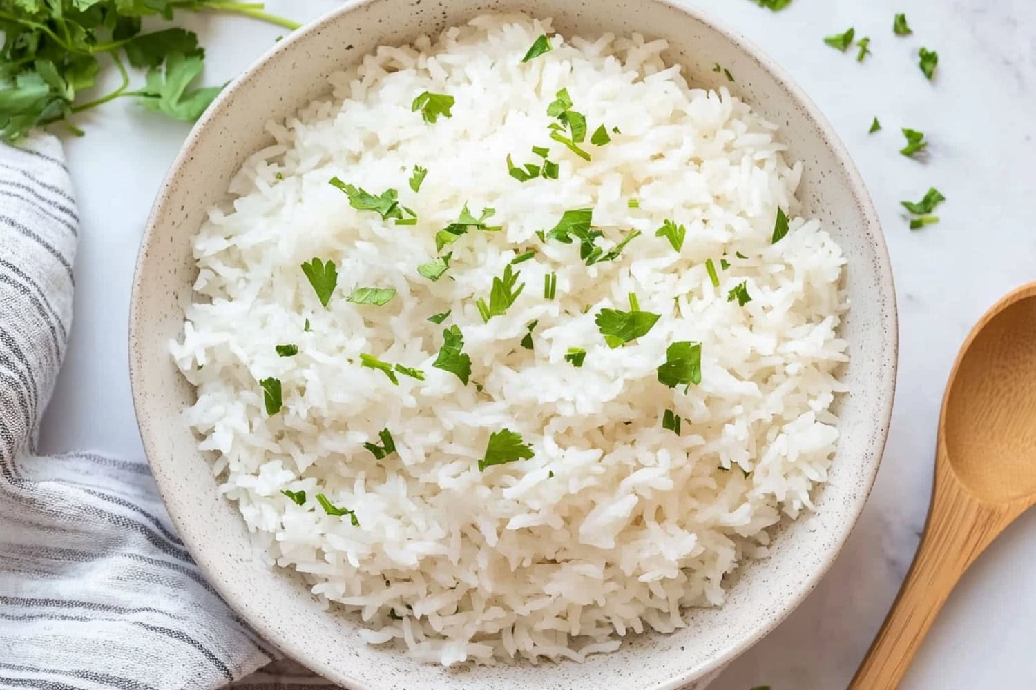 An overhead view of coconut rice sprinkled with chopped parsley for garnish.