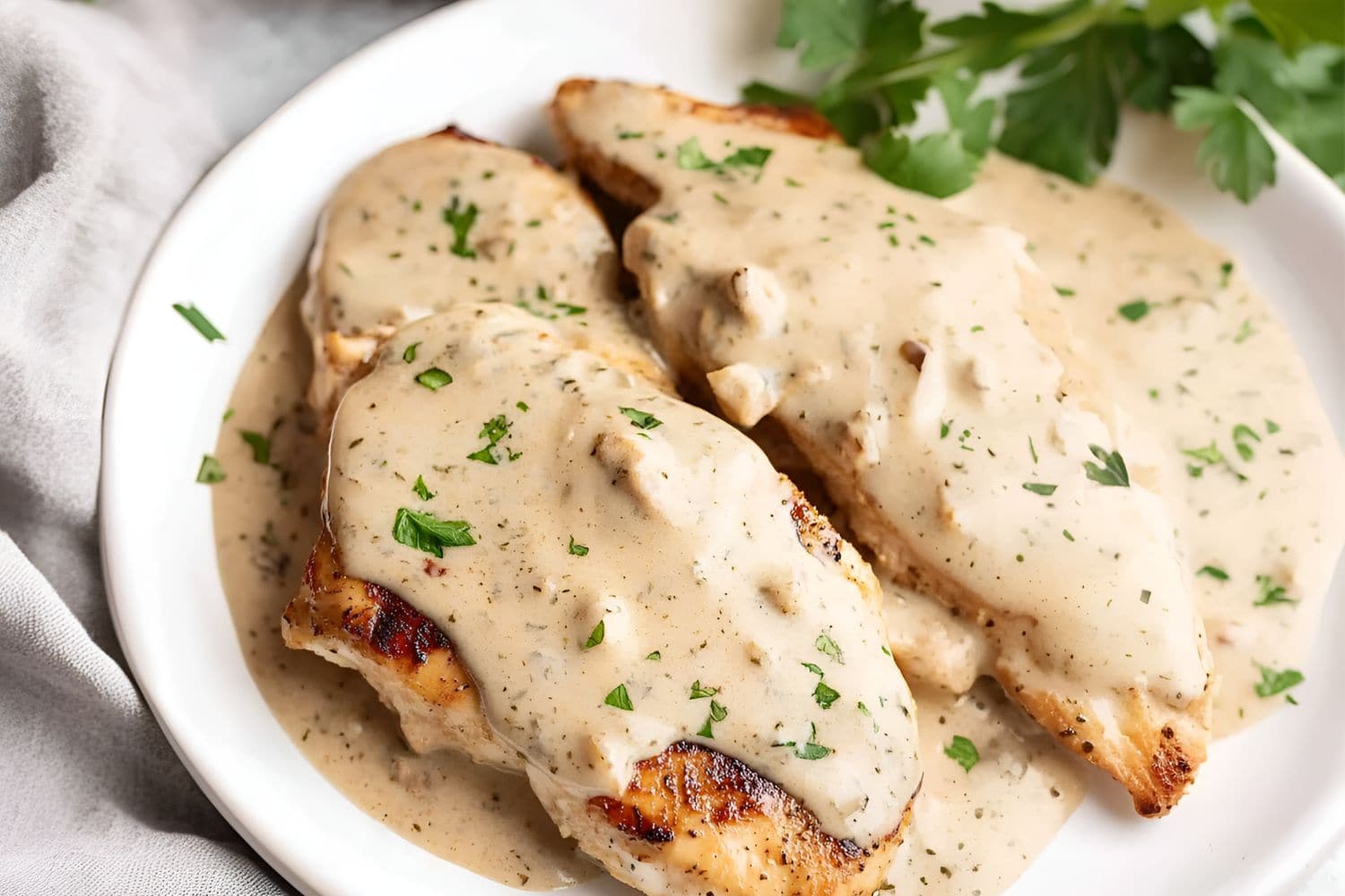 Cream cheese chicken served on a white plate.