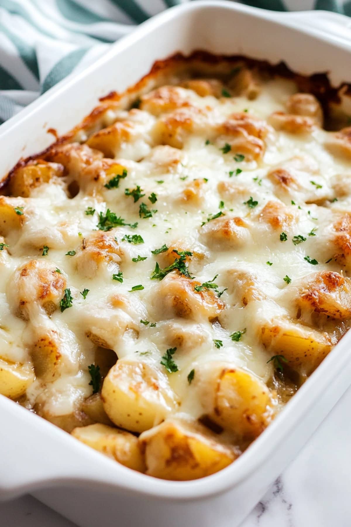 Creamy potatoes with cheesy french onion soup in a baking dish.