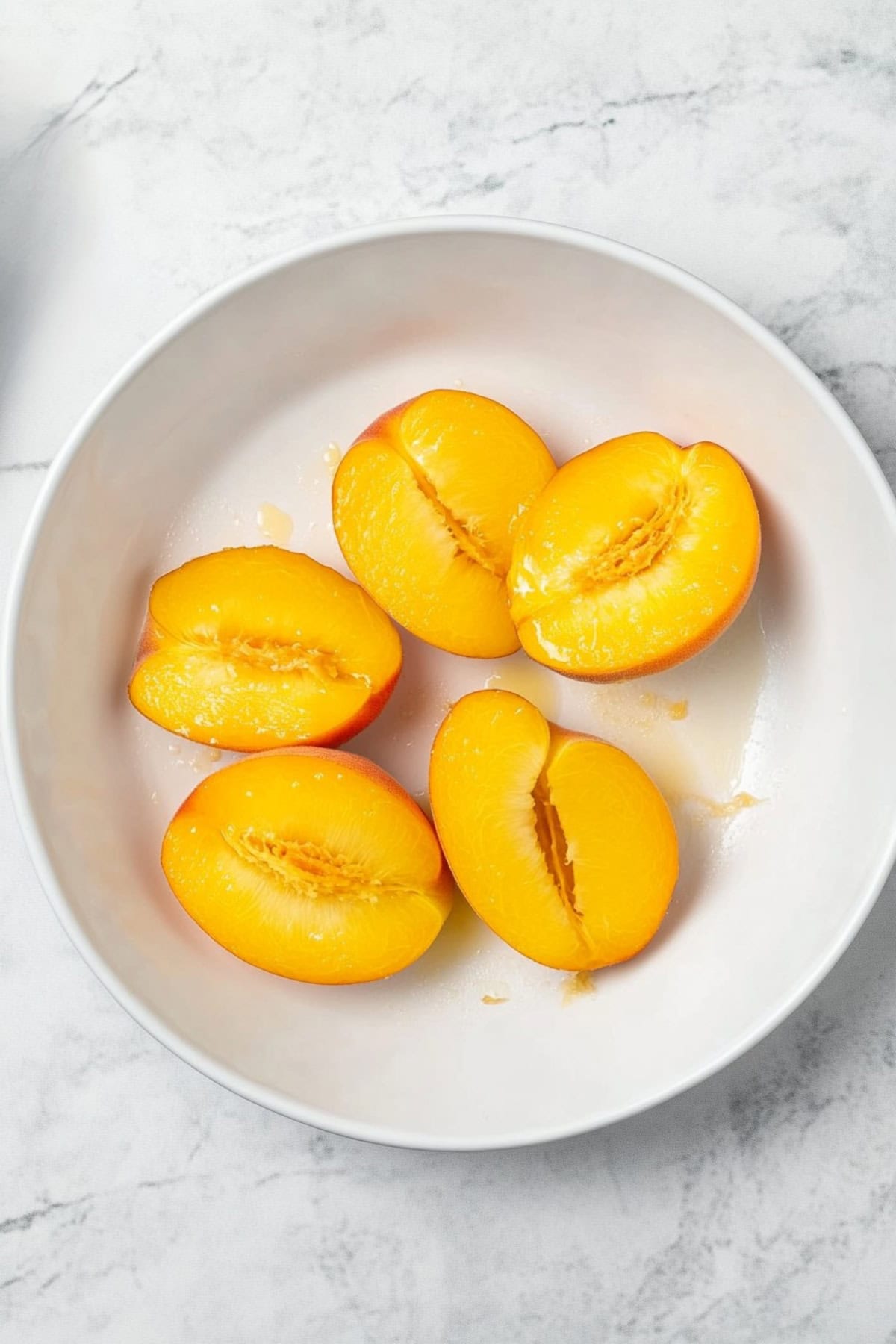 A plate of fresh peaches, top view.