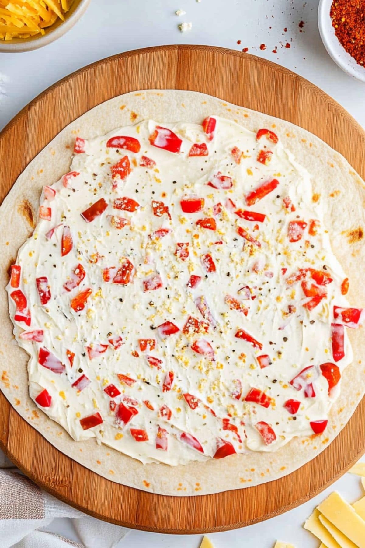 Corn tortilla with even spread of cream cheese mixture.