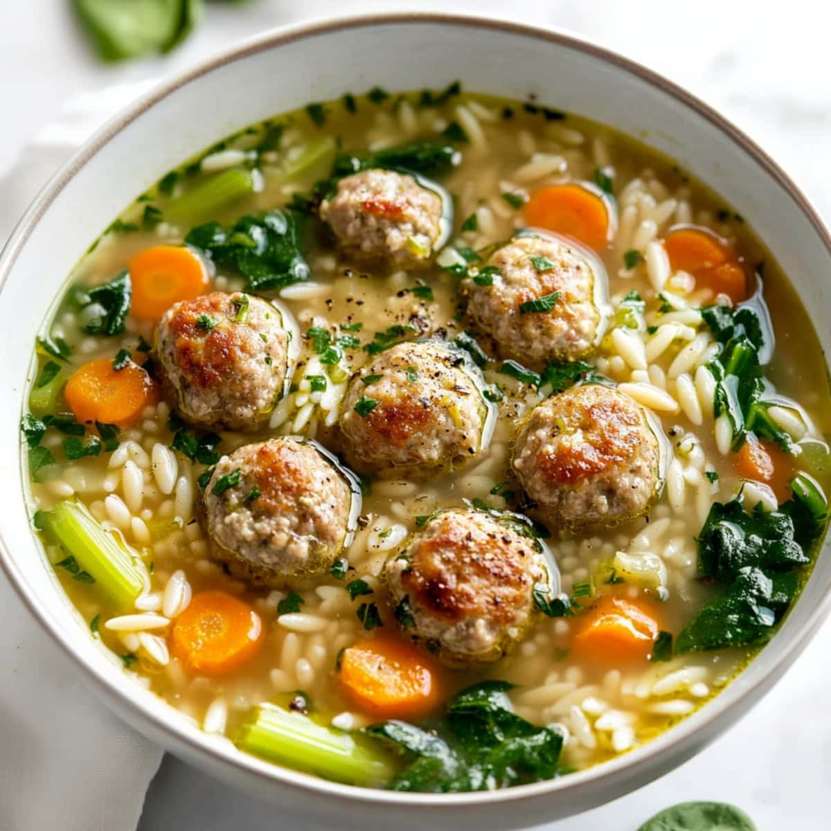 Italian wedding soup with meatballs and veggies.