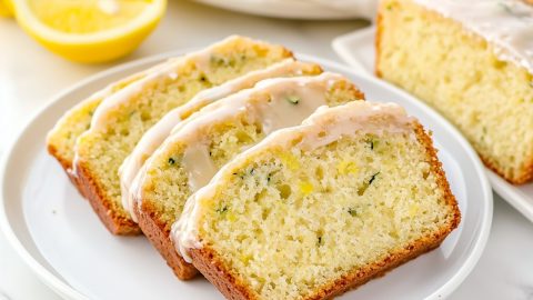 Homemade lemon zucchini bread slices on a white plate