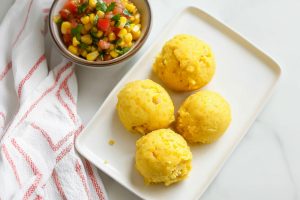 Mexican sweet corn cake, served with a bowl of salsa.