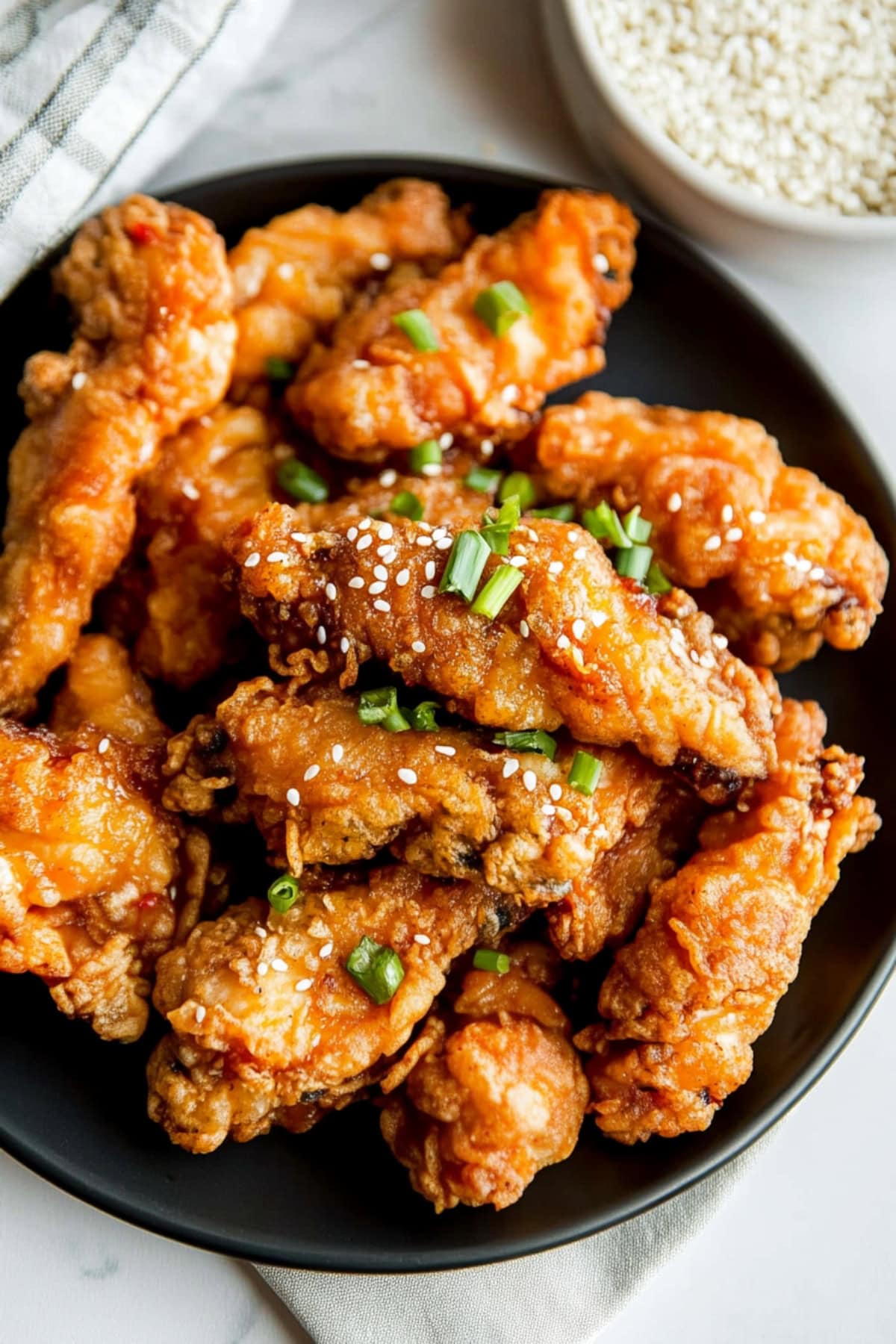 Crispy fried chicken strips in Mochiko flour in a black plate.