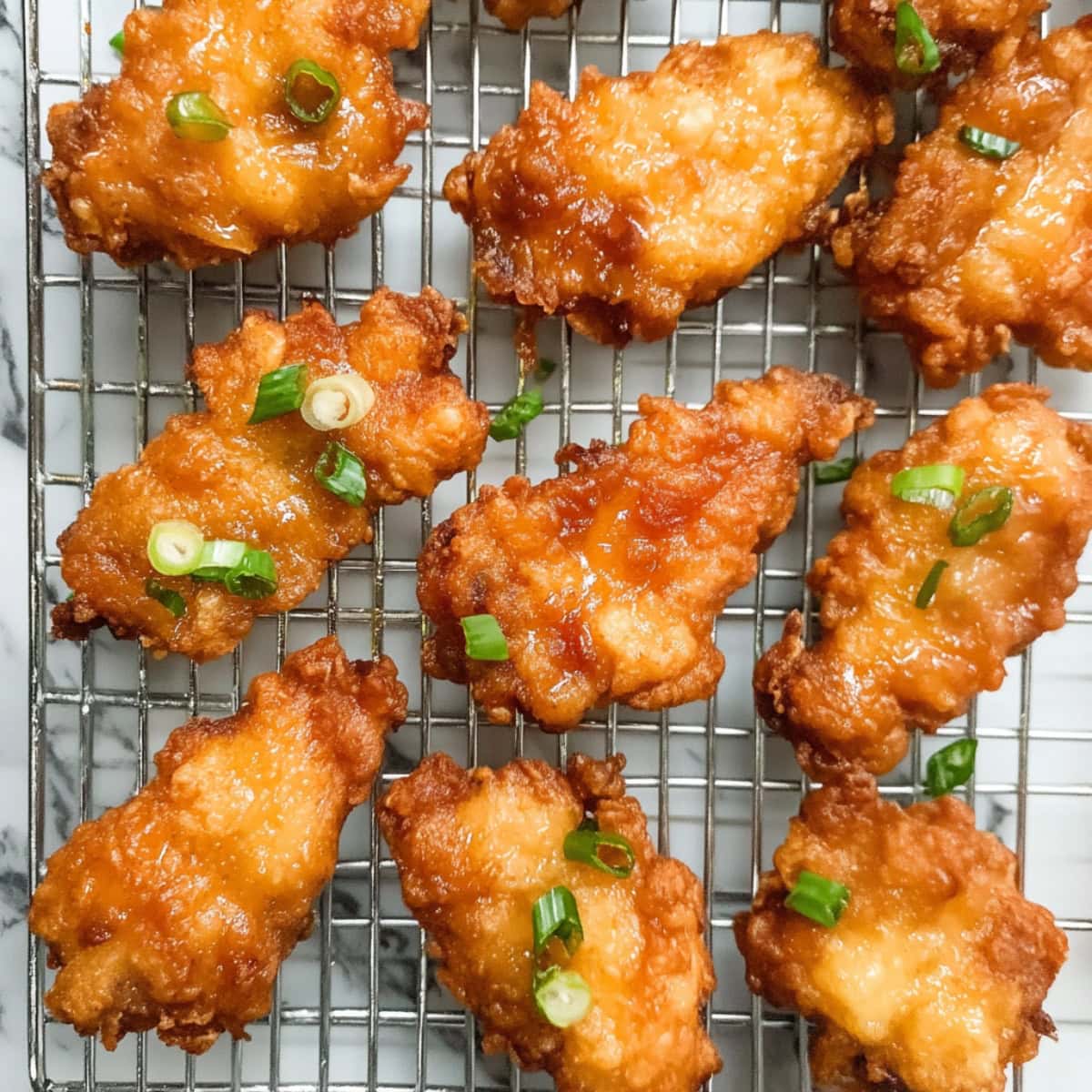 An overhead view of Mochiko chicken in a cooling rack.