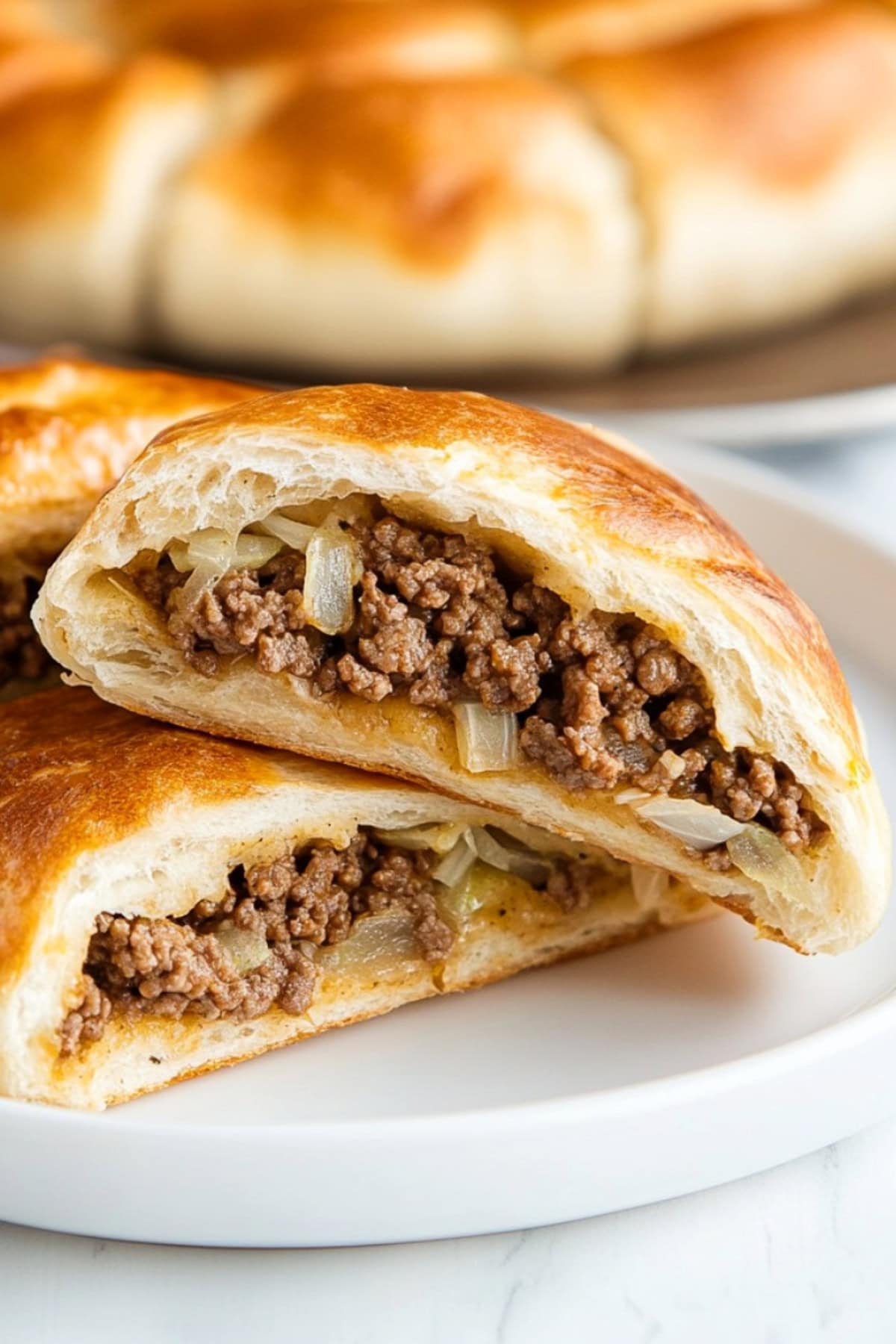 Runzas with ground beef and veggies served on a ceramic plate