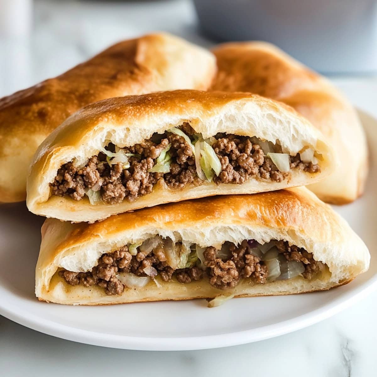 A close-up shot of Runzas or dough bread filled with ground beef and vegetables.