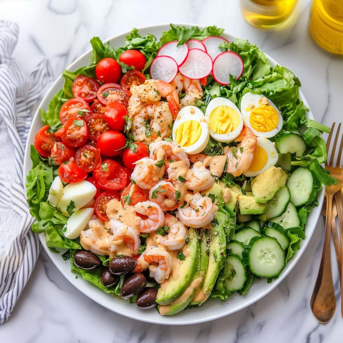 An overhead view of shrimp louie salad with eggs and vegeetables.