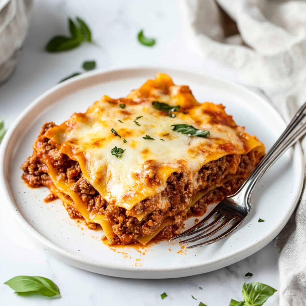 Serving of skillet lasagna in a white plate.
