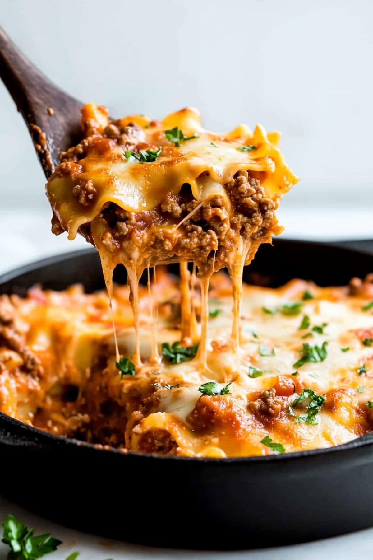 Cheesy lasagna cooked in a skillet. 