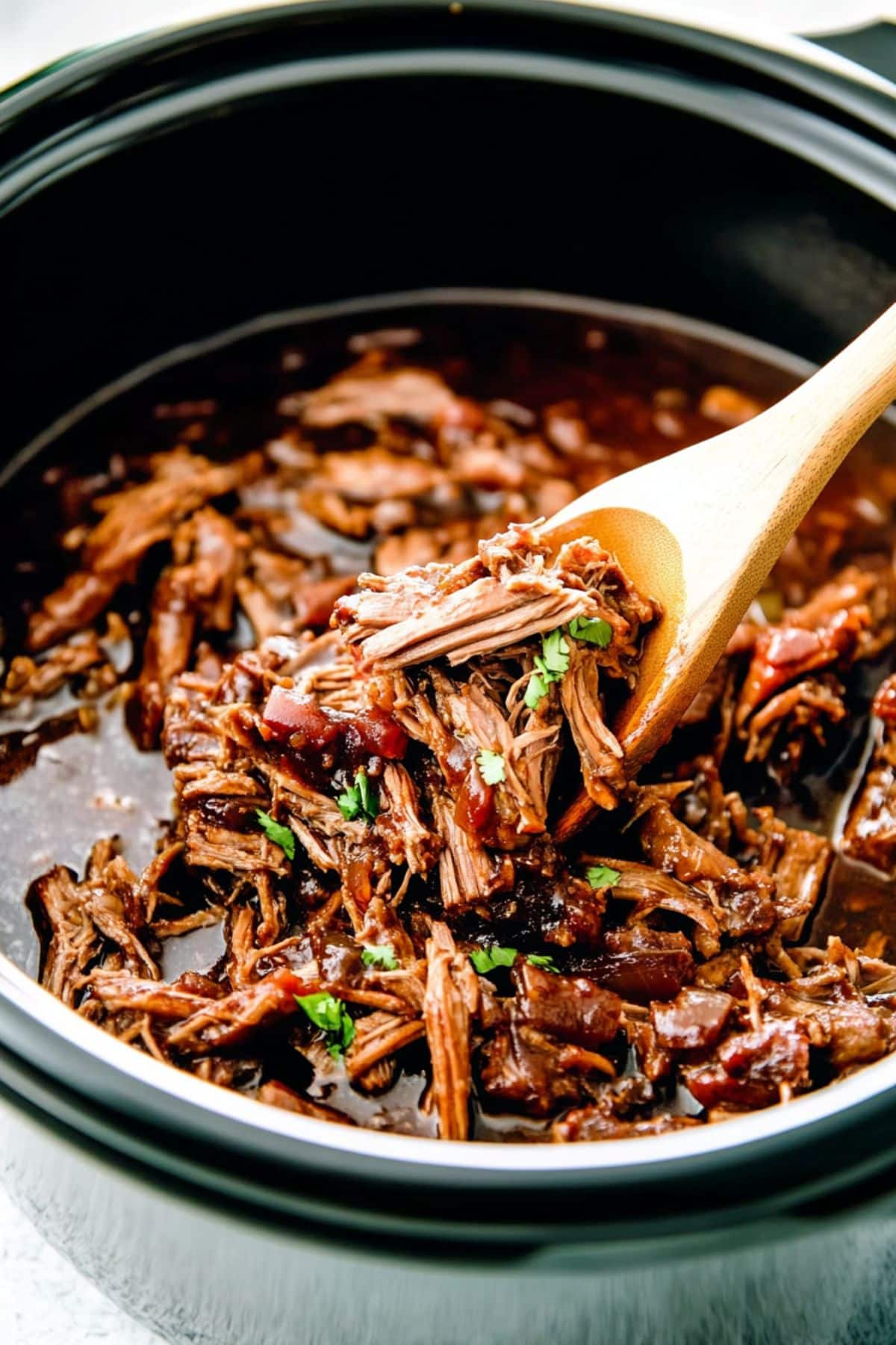 Pulled pork cooked inside a slow cooker. 