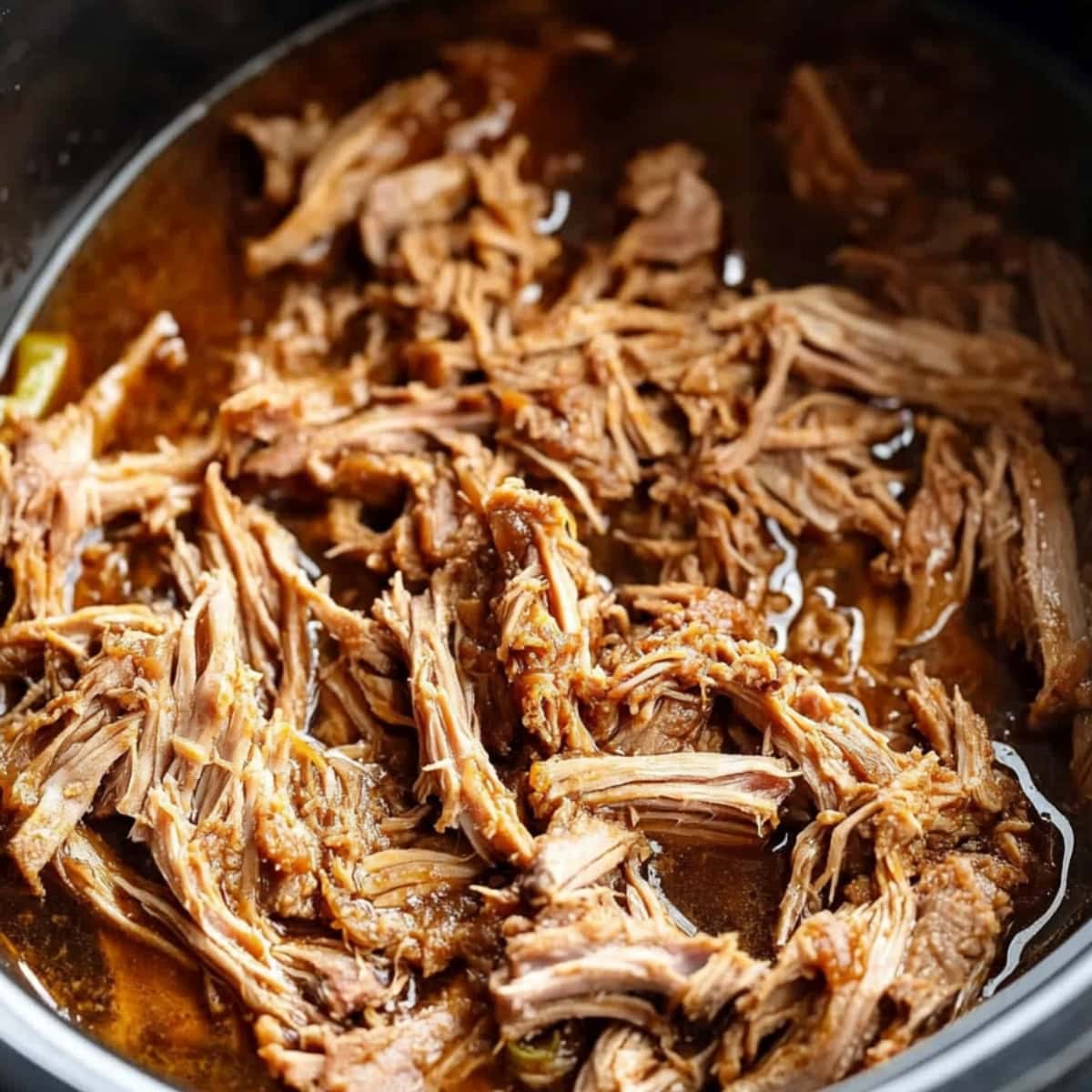 Shredded pork shoulder in spice mixture cooked in a slow cooker.