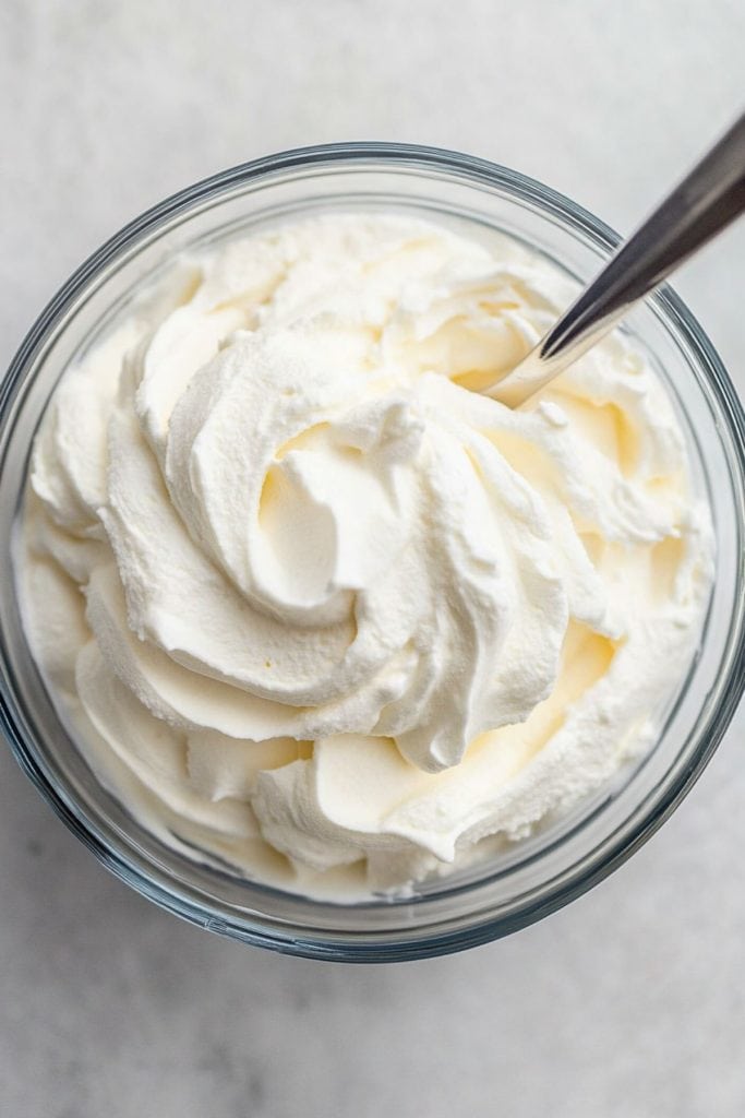 Whipped cream in a glass bowl.