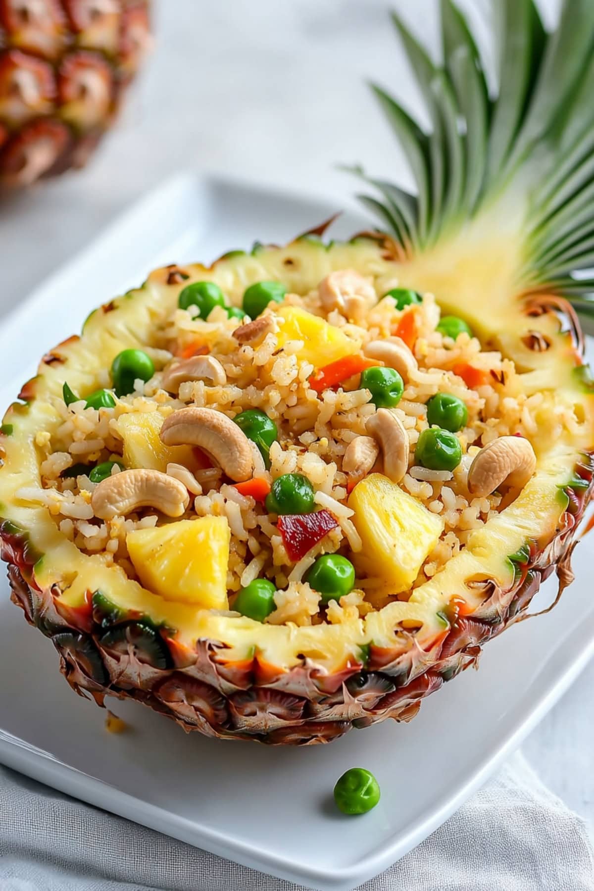 Pineapple fried rice served in a hollowed pineapple.