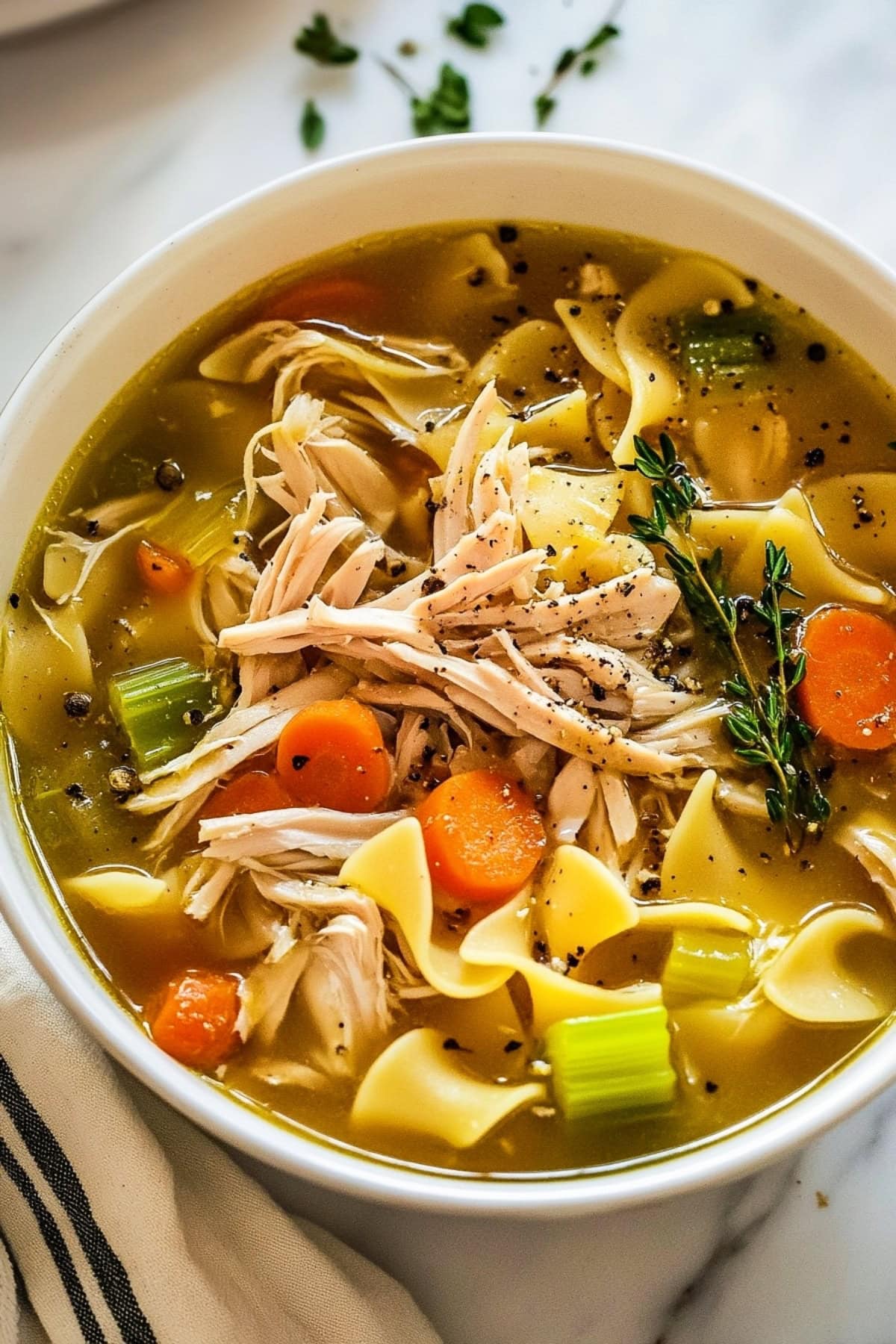 Homemade turkey noodle soup with carrots and celery in a rich savory broth