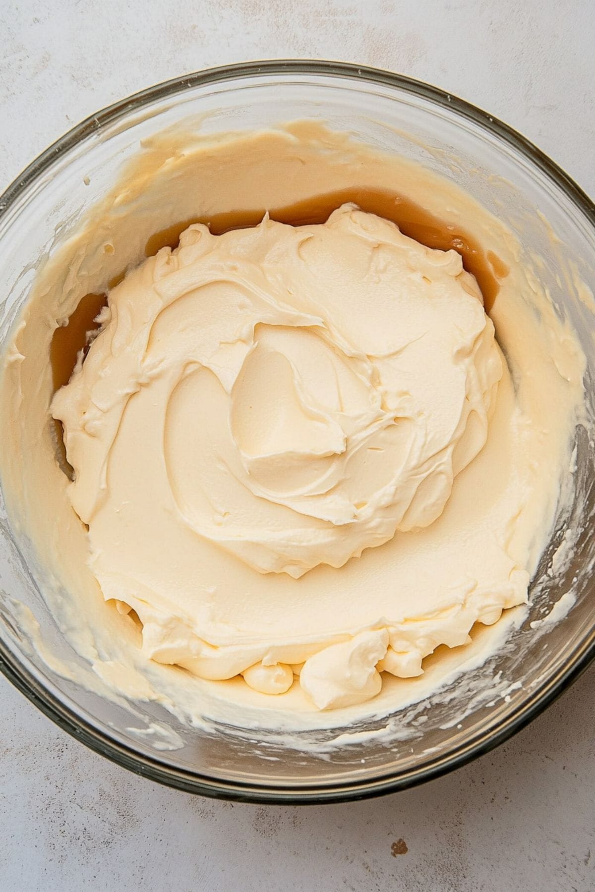 Caramel whipped cream in a glass mixing bowl.