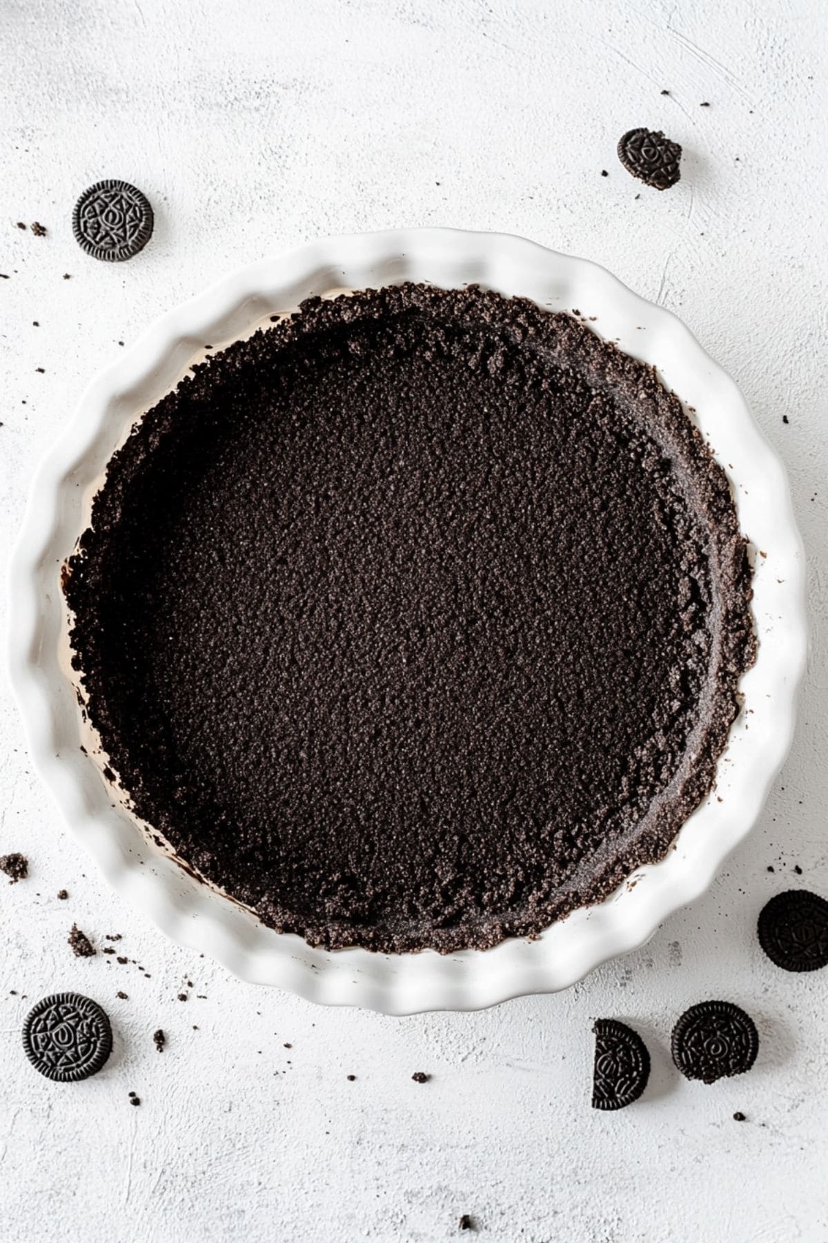 Oreo crust in a pie dish.