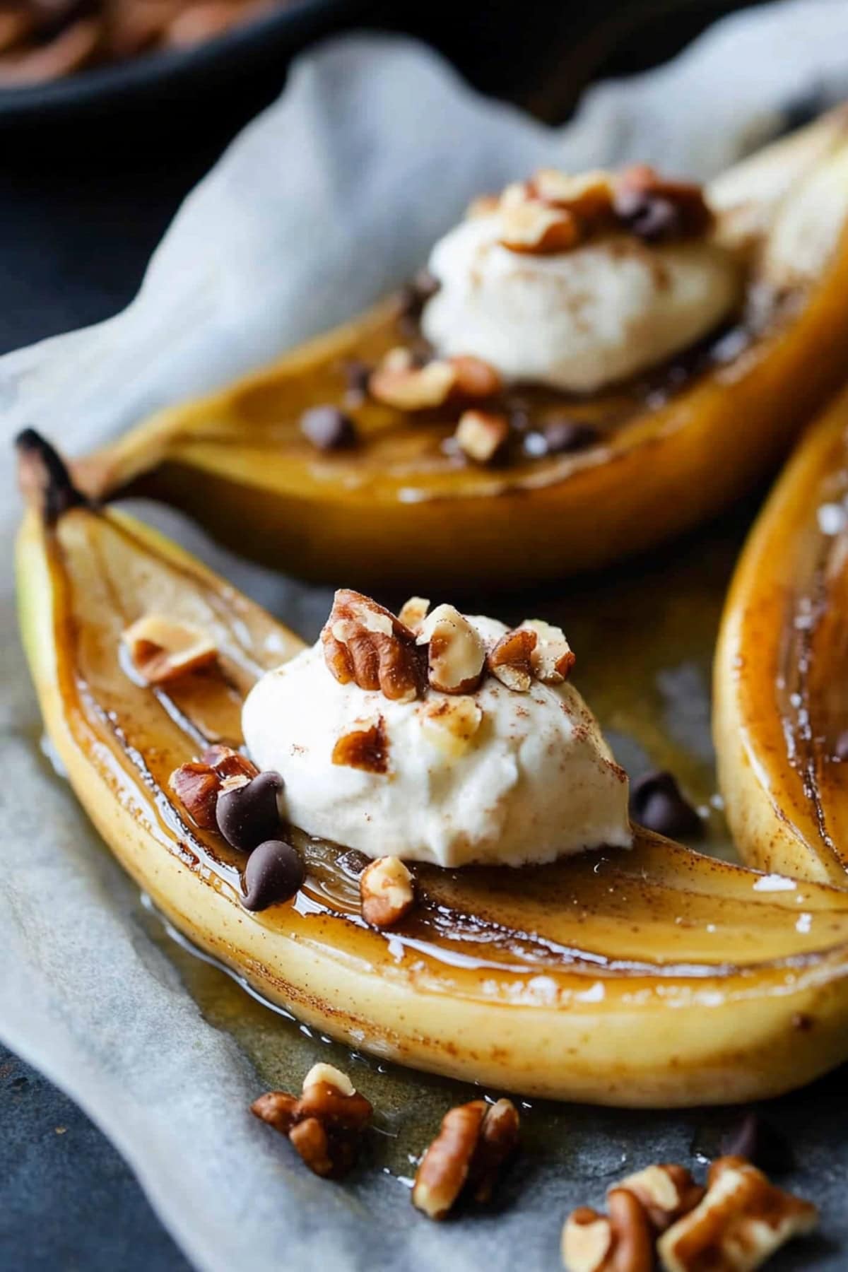 Caramelized bananas in a parchment paper, drizzled with maple syrup.