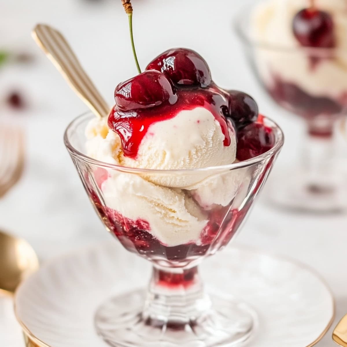 Cherries Jubilee with scoops of vanilla ice cream