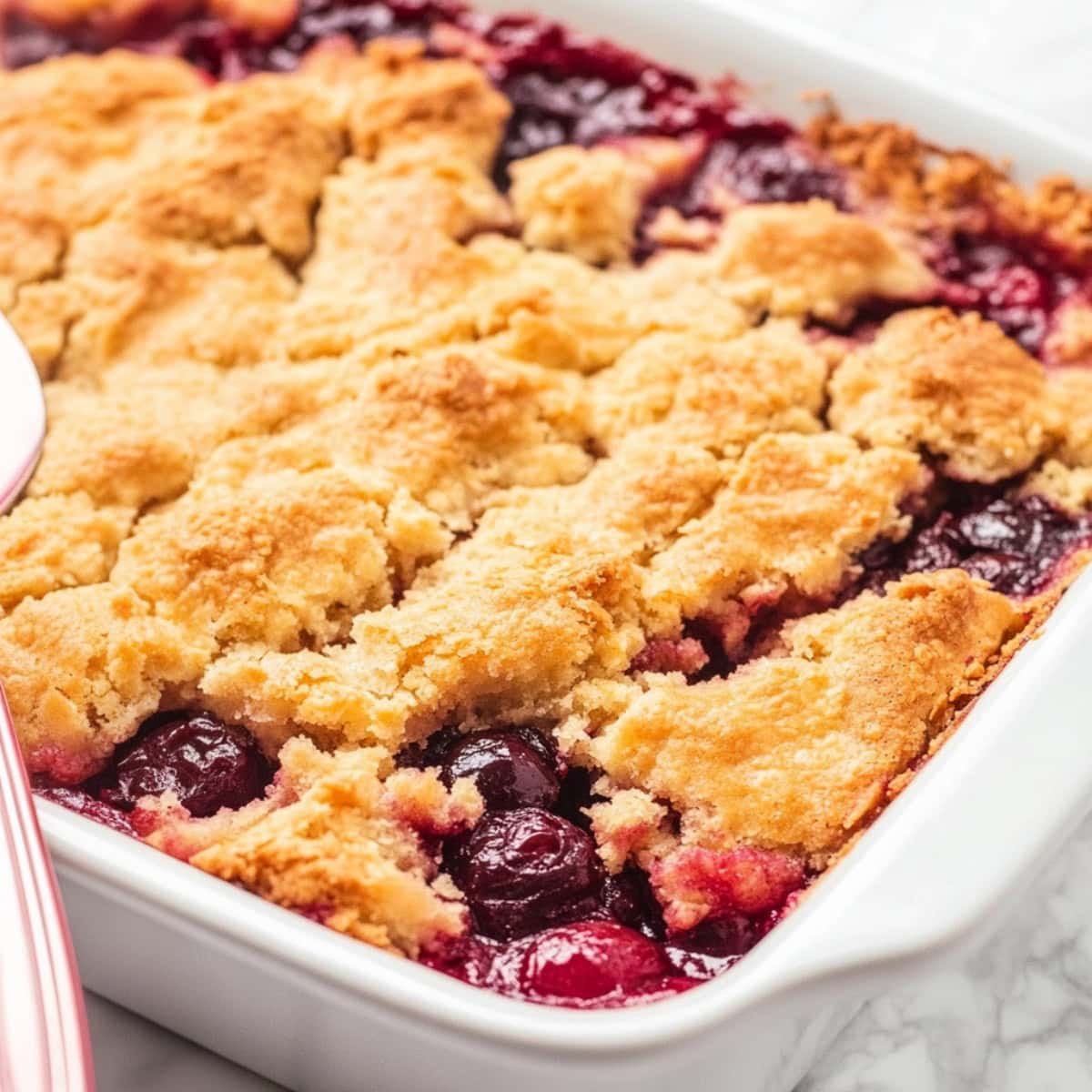 Cherry Pineapple Dump Cake in a baking dish, close up