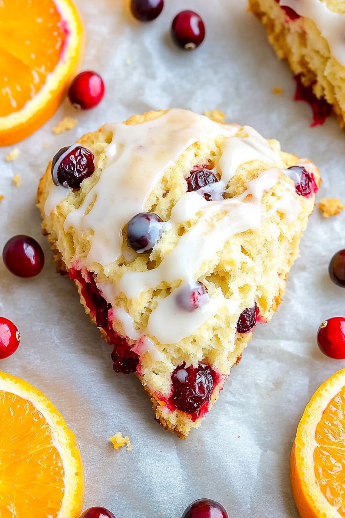 Freshly baked homemade cranberry orange scones with glaze.