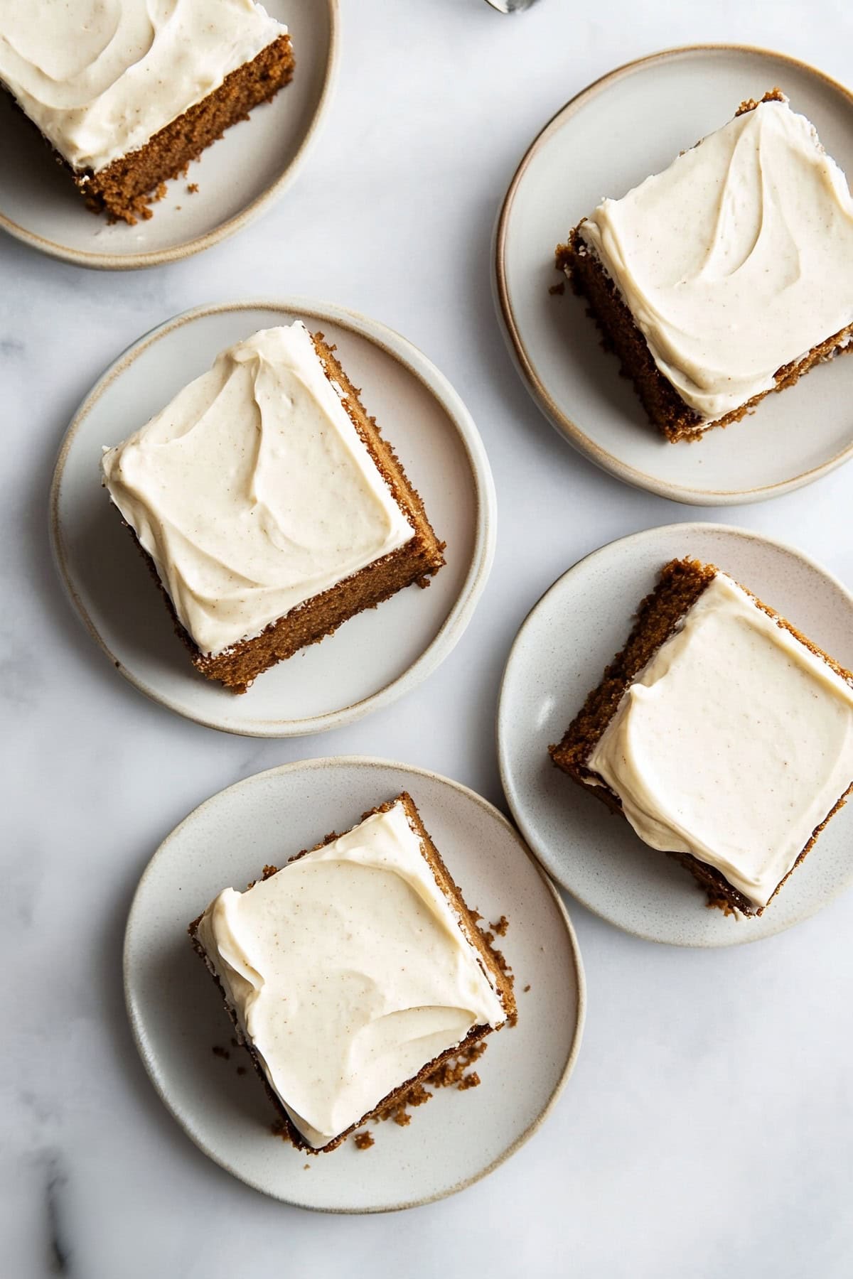 An overhead view of five slices of gingerbread sheet cake squares in a plate.