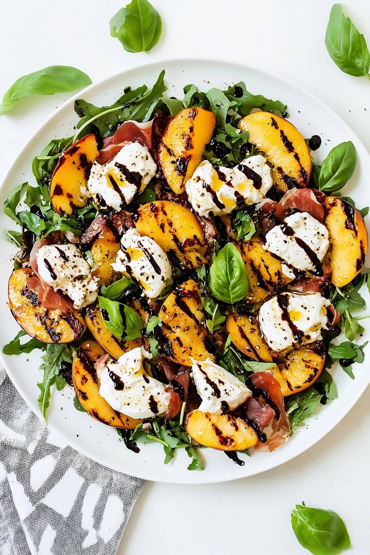 Juicy grilled peaches and creamy burrata with prosciutto.