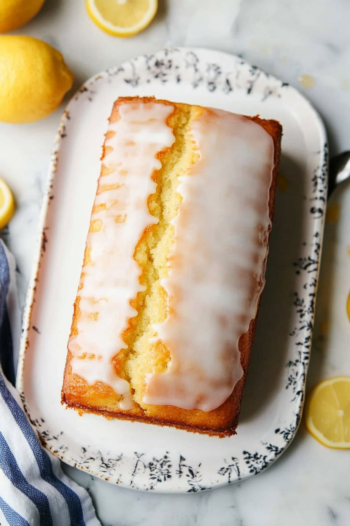 An overhead view of lemon yogurt cake with glaze on a plate