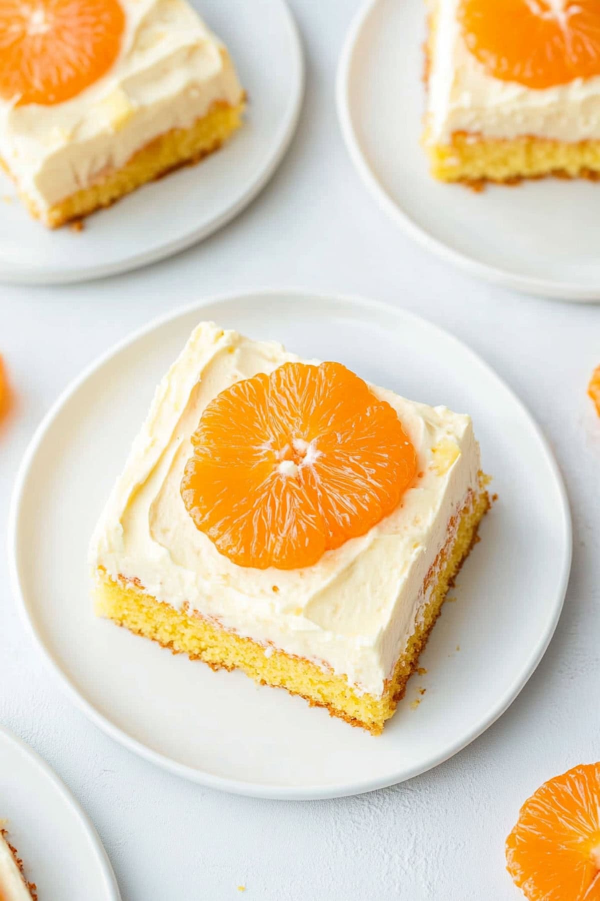 Slice of mandarin orange cake on a white plate, top view