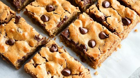 peanut butter chocolate chip bars on a white parchment paper.