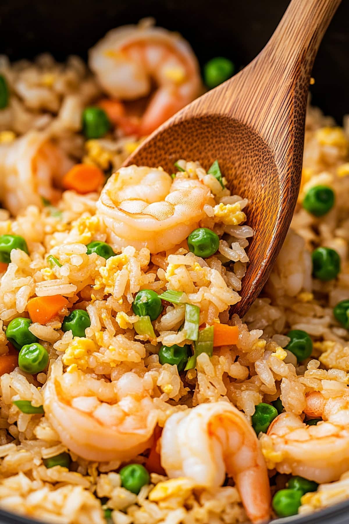 Homemade shrimp fried rice with green peas, carrots, eggs and herbs.