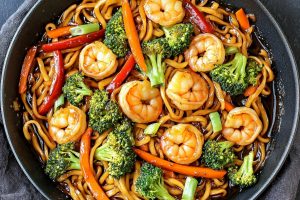 Stir fried lo mein noodles with shrimp, broccoli and bell peppers.