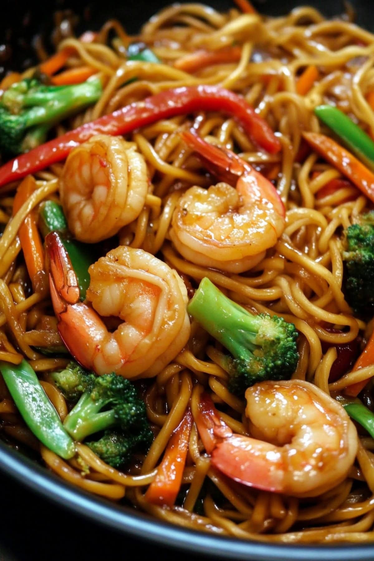 Platter of stir fry shrimp with noodles.