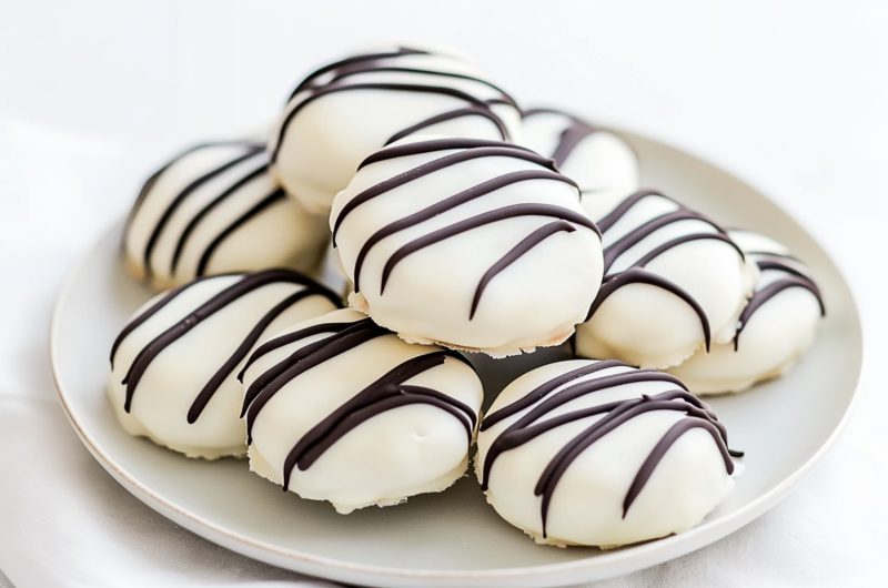 A batch of white chocolate-covered Oreos, each cookie with a thick, creamy white chocolate shell.