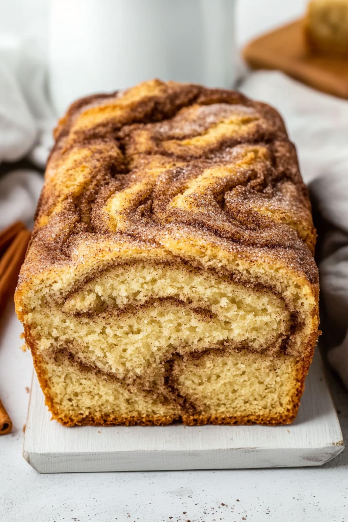 Cinnamon loaf bread sitting on a white board.