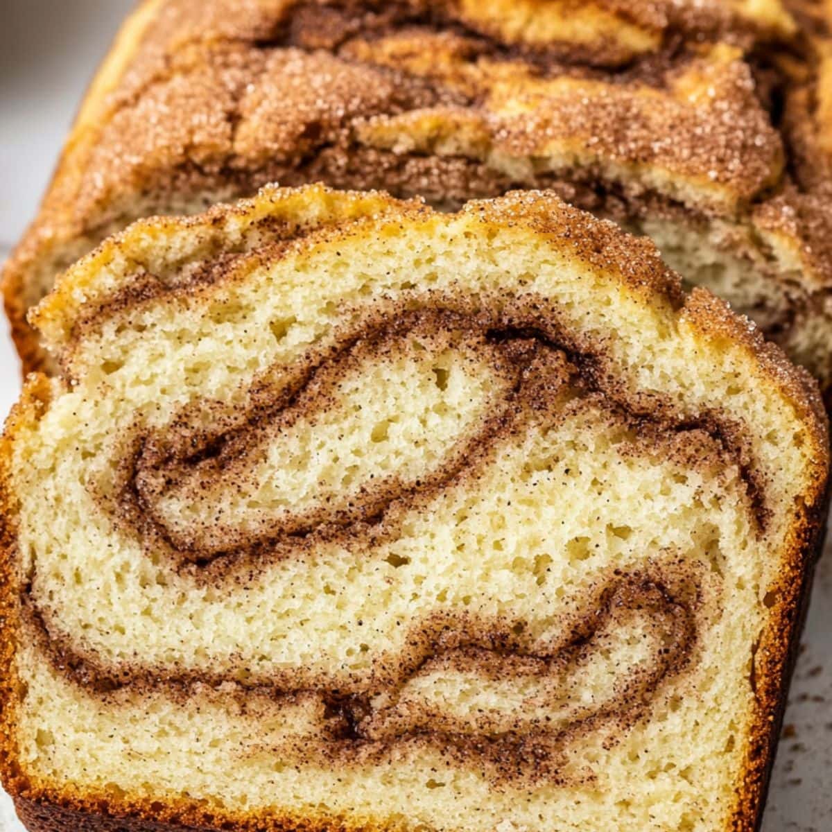 Slices of cinnamon loaf bread in a white plate.