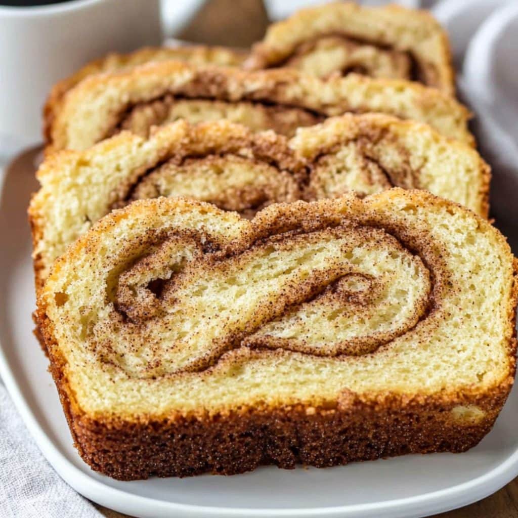 Slices of Amish cinnamon bread served in a white plate.