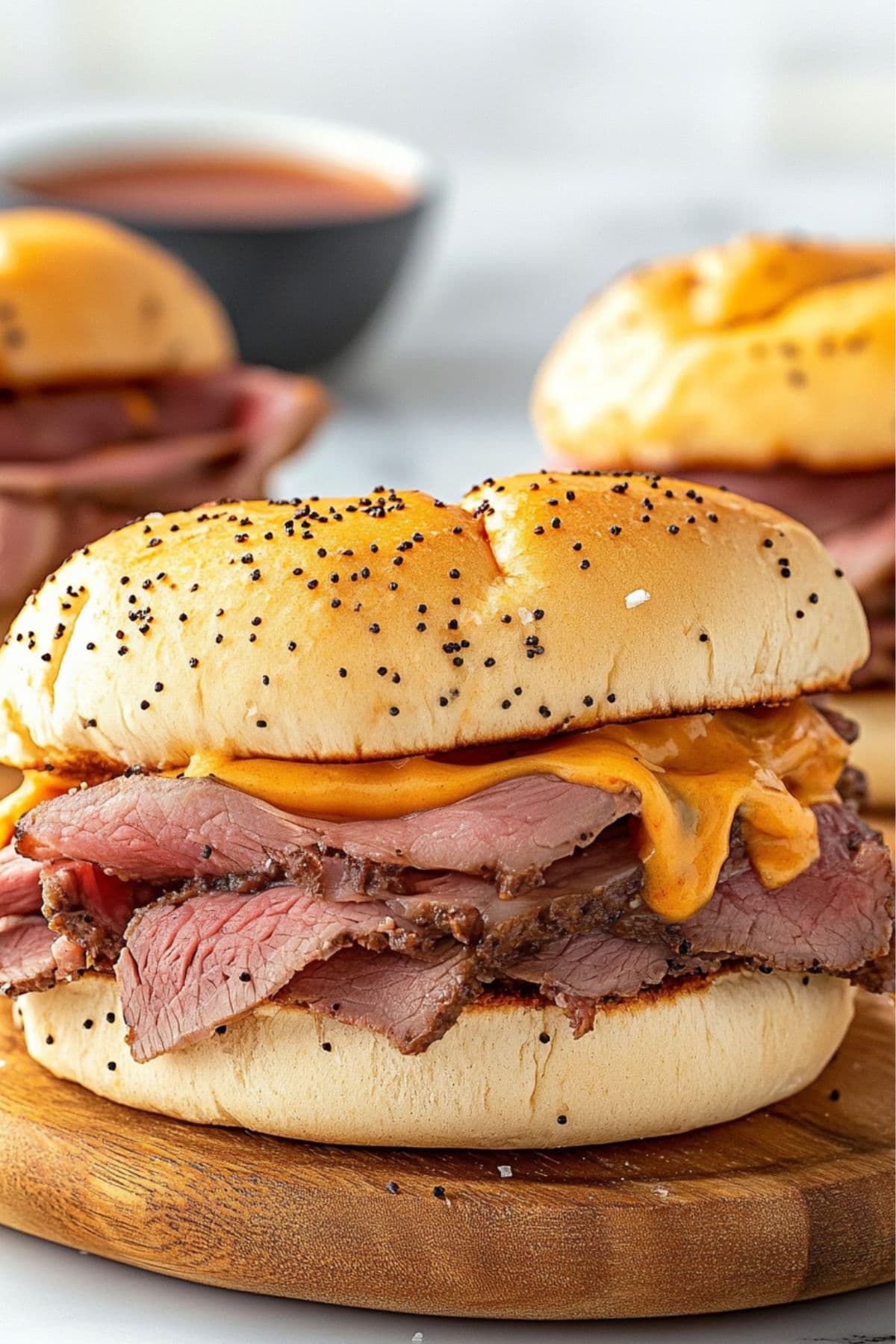 Thinly sliced roast beef sandwich in onion buns dripping with cheddar sauce.