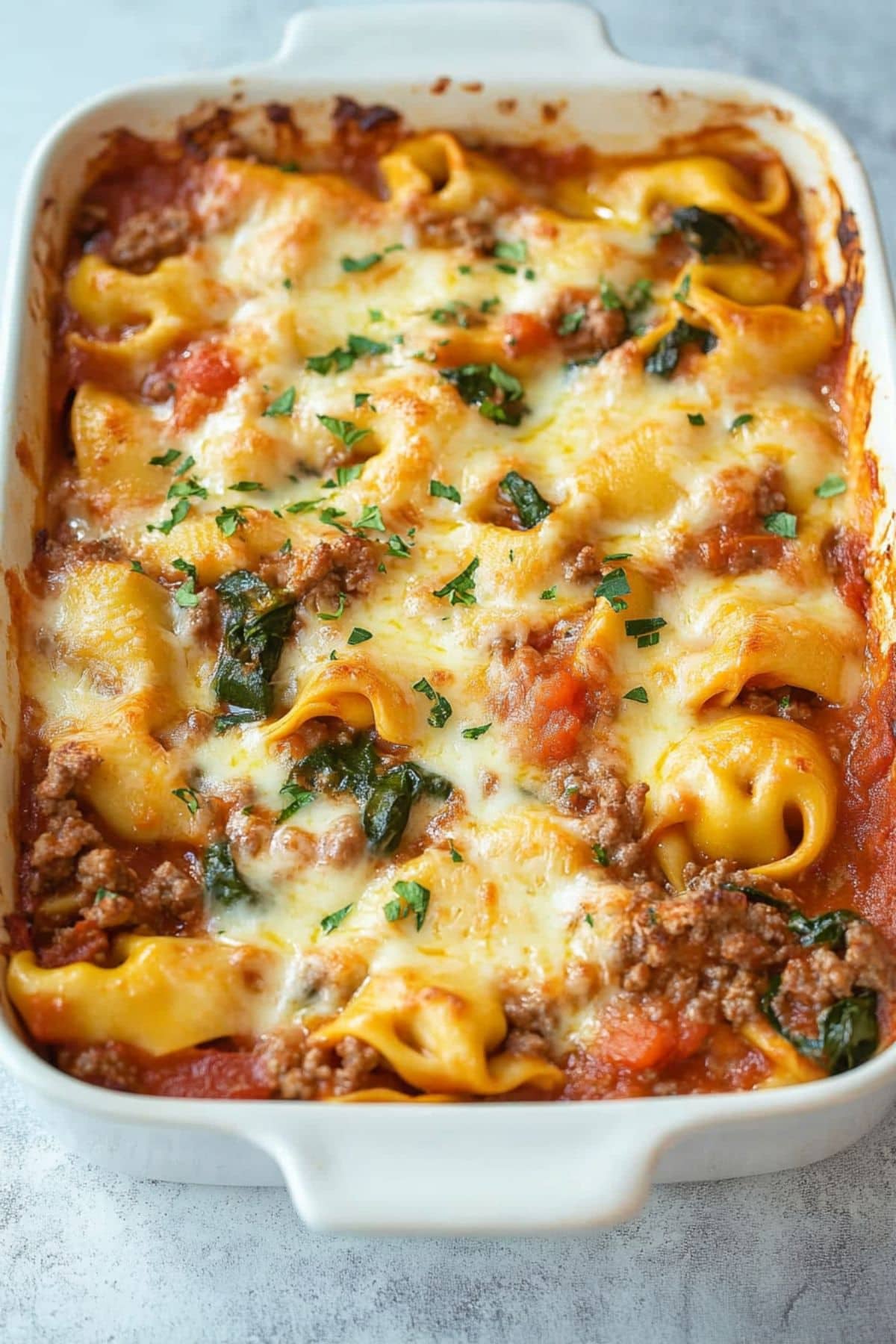 Baked tortellini in a rectangular baking dish.