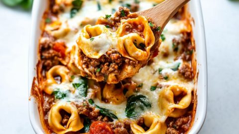 Baked tortellini in a white baking dish.