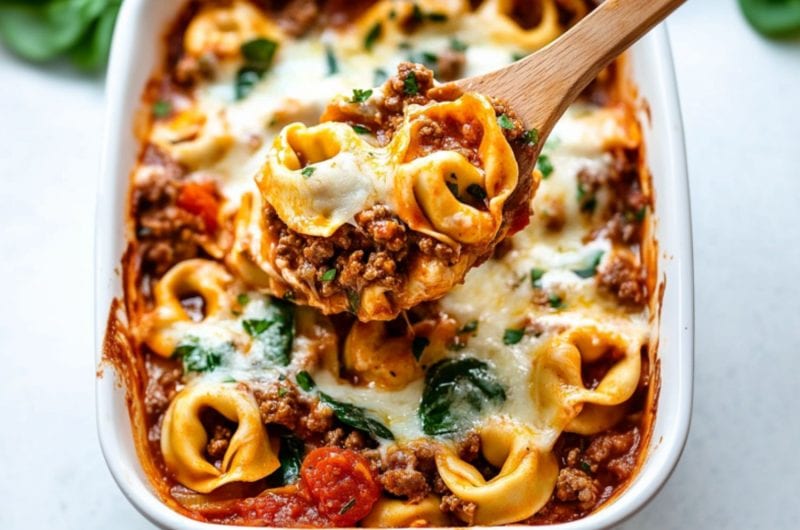 Baked tortellini in a white baking dish.