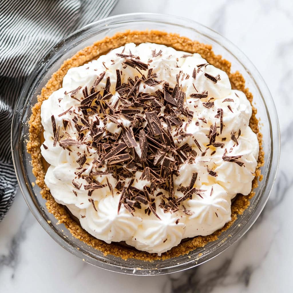 Banoffee Pie with whipped cream and chocolate shavings, top view