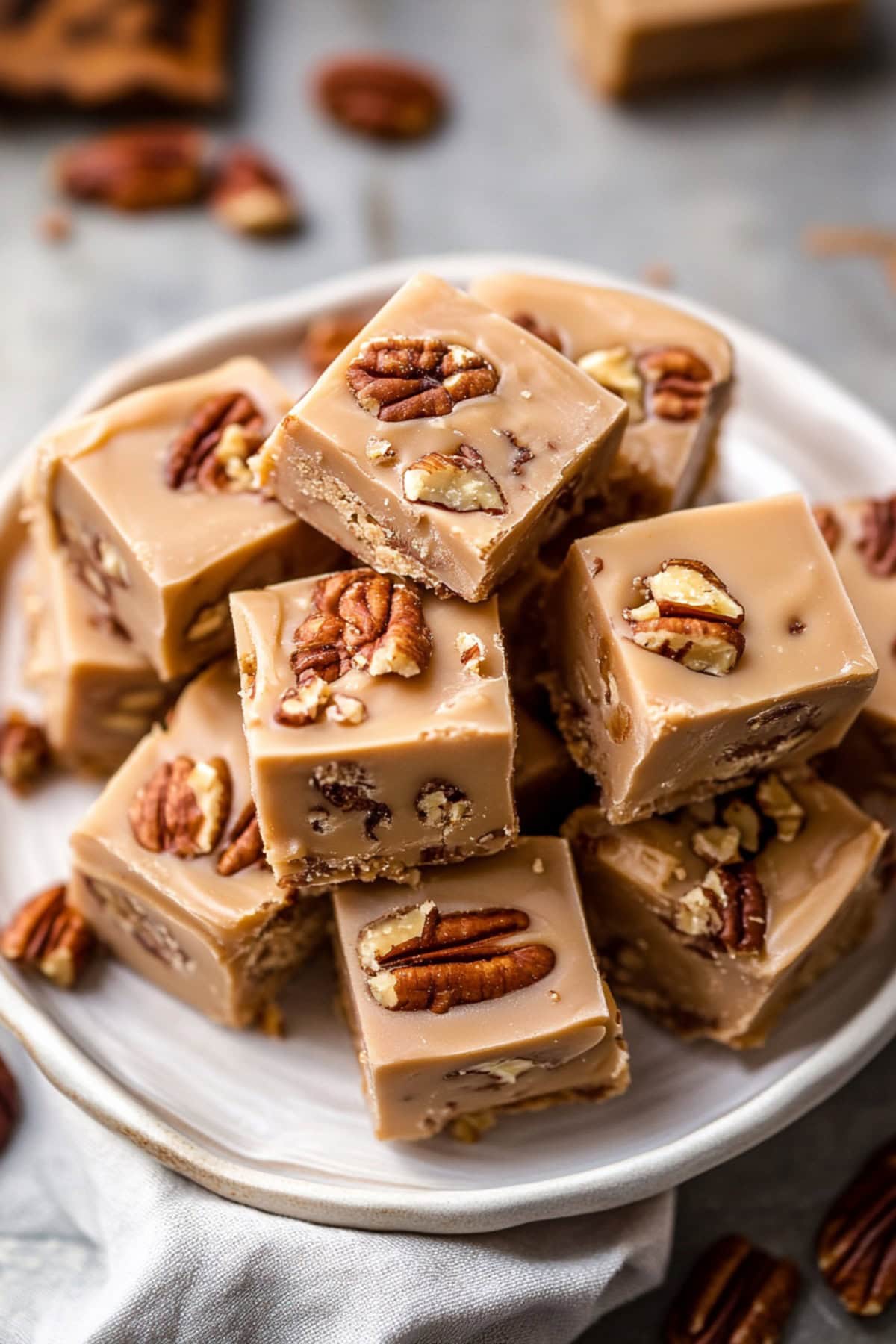 Plate of white chocolate fudge with toasted pecans