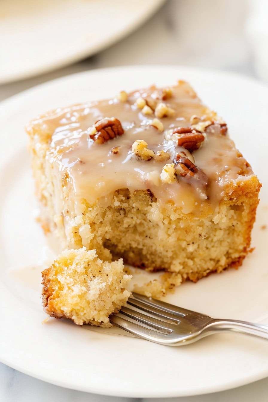 Close-up of praline poke cake with pecans.