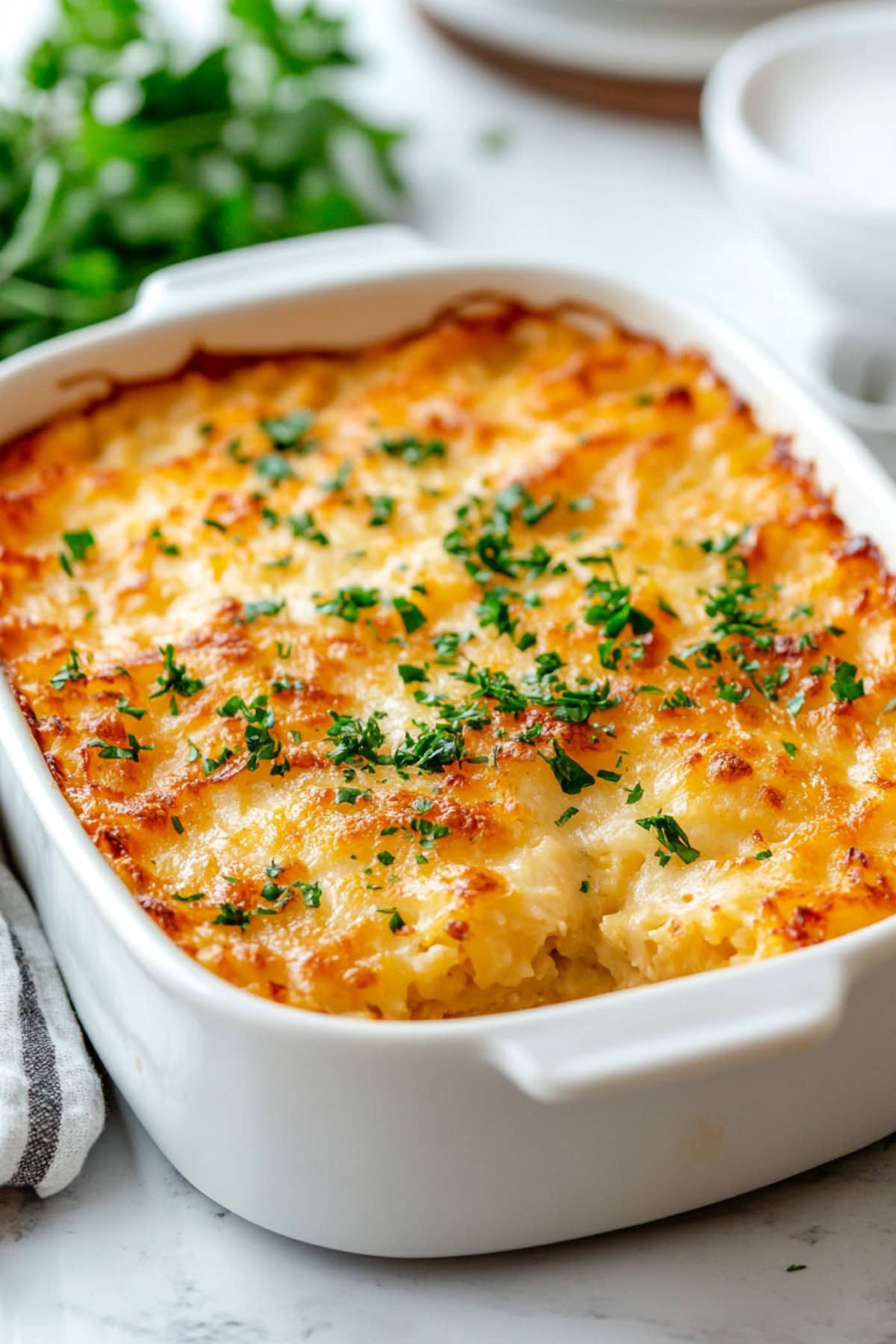 Cheesy Hashbrown Casserole in a white baking dish