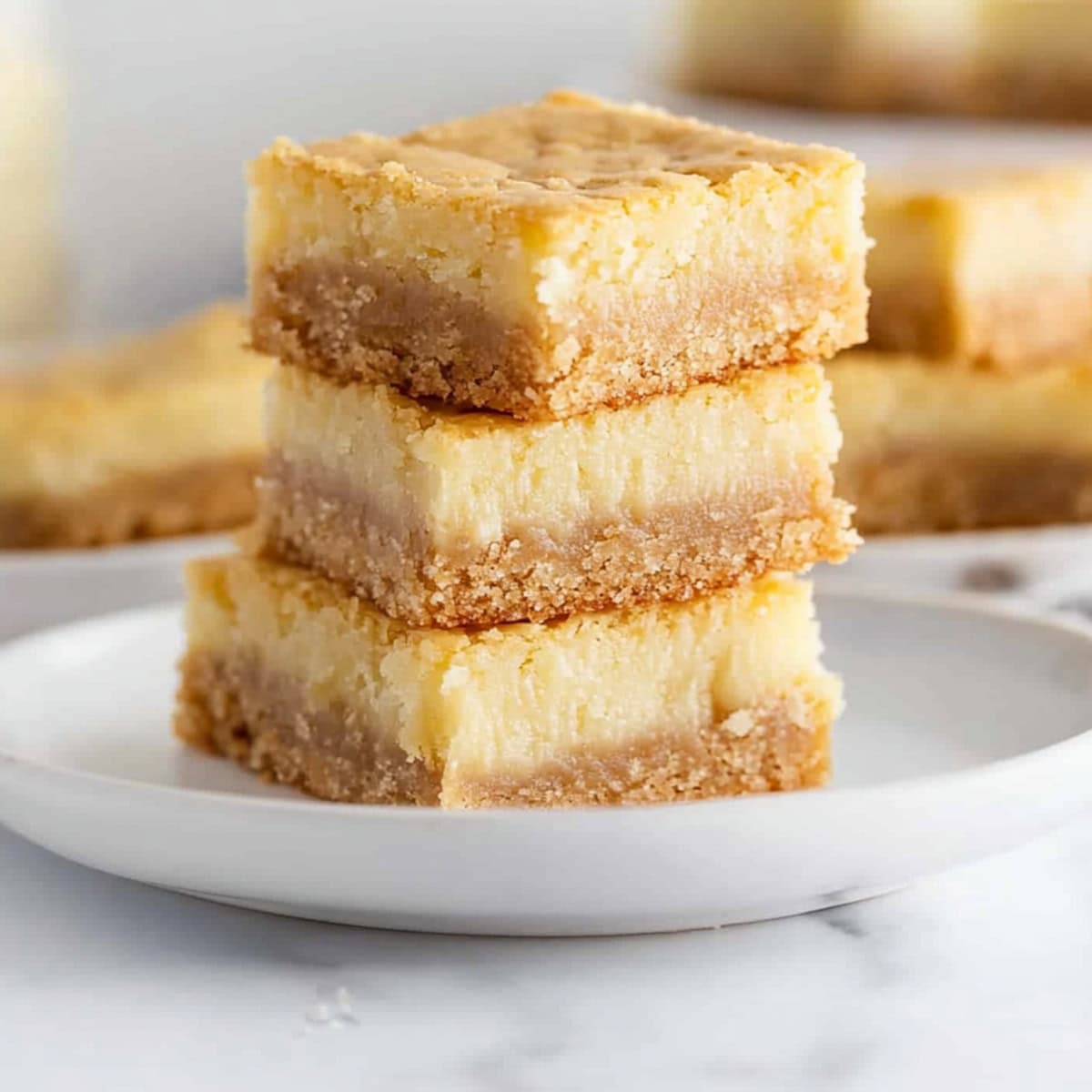 Three chess squares stacked on top of each other on a white plate.