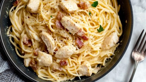 Homemade creamy and savory chicken carbonara with bacon bits, parmesan and herbs.