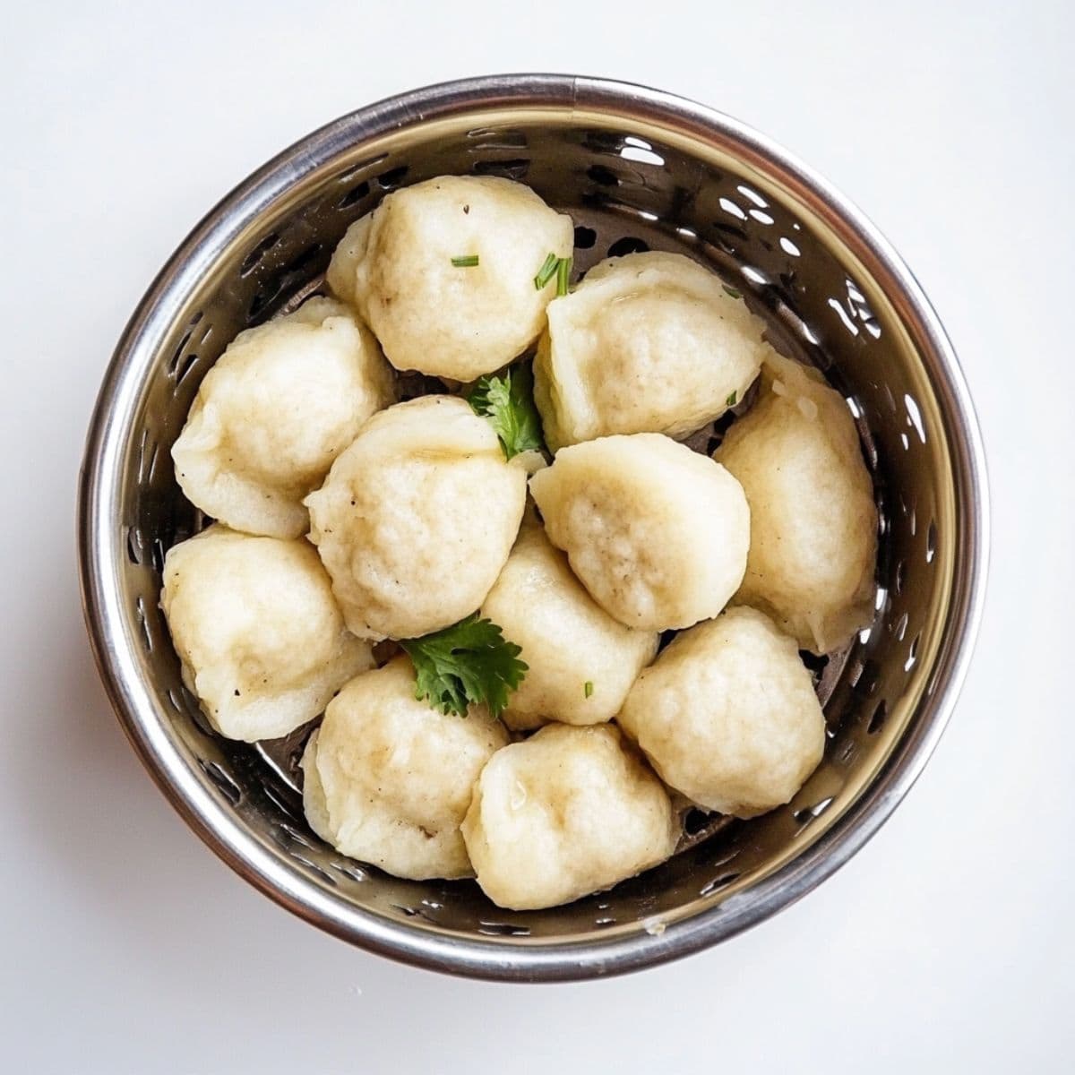 Flour dumplings in a metal coriander.